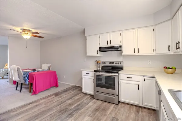 a kitchen with a white cabinets and black appliances