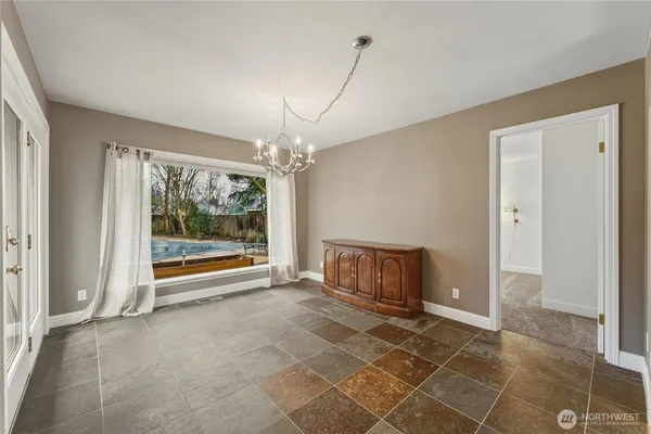 a view of a dining room with furniture and chandelier