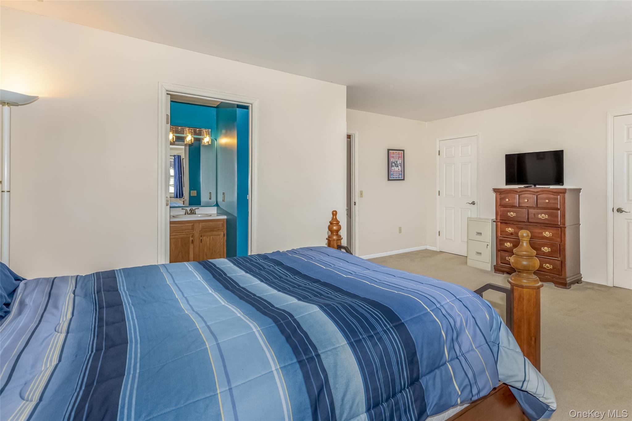 57 Winding Brook Drive Walden, NY 12586 - Photo 22 of 33 a bedroom with a bed and a flat screen tv