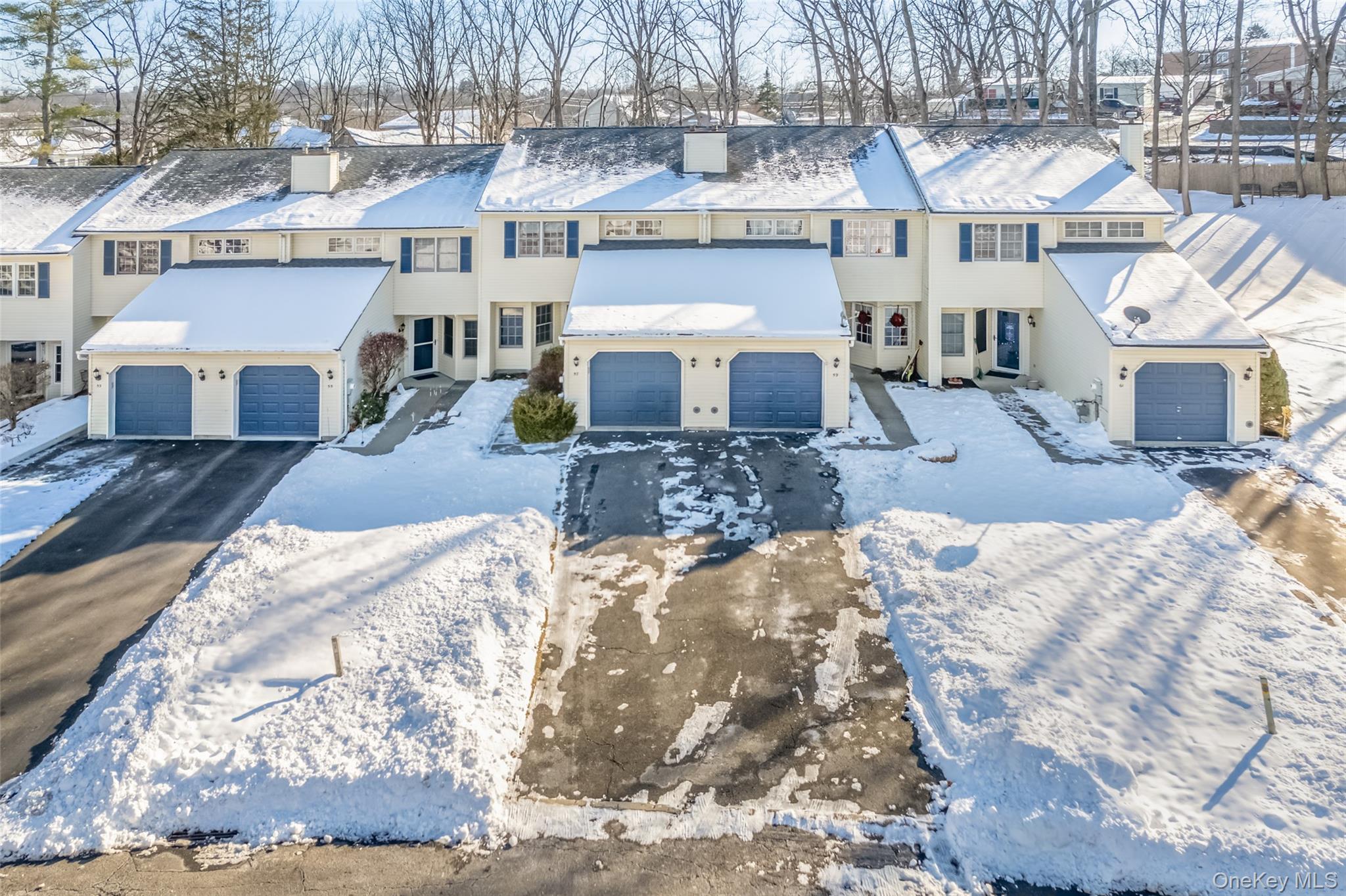 57 Winding Brook Drive Walden, NY 12586 - Photo 4 of 33 a view of a house with a yard covered with snow in the background