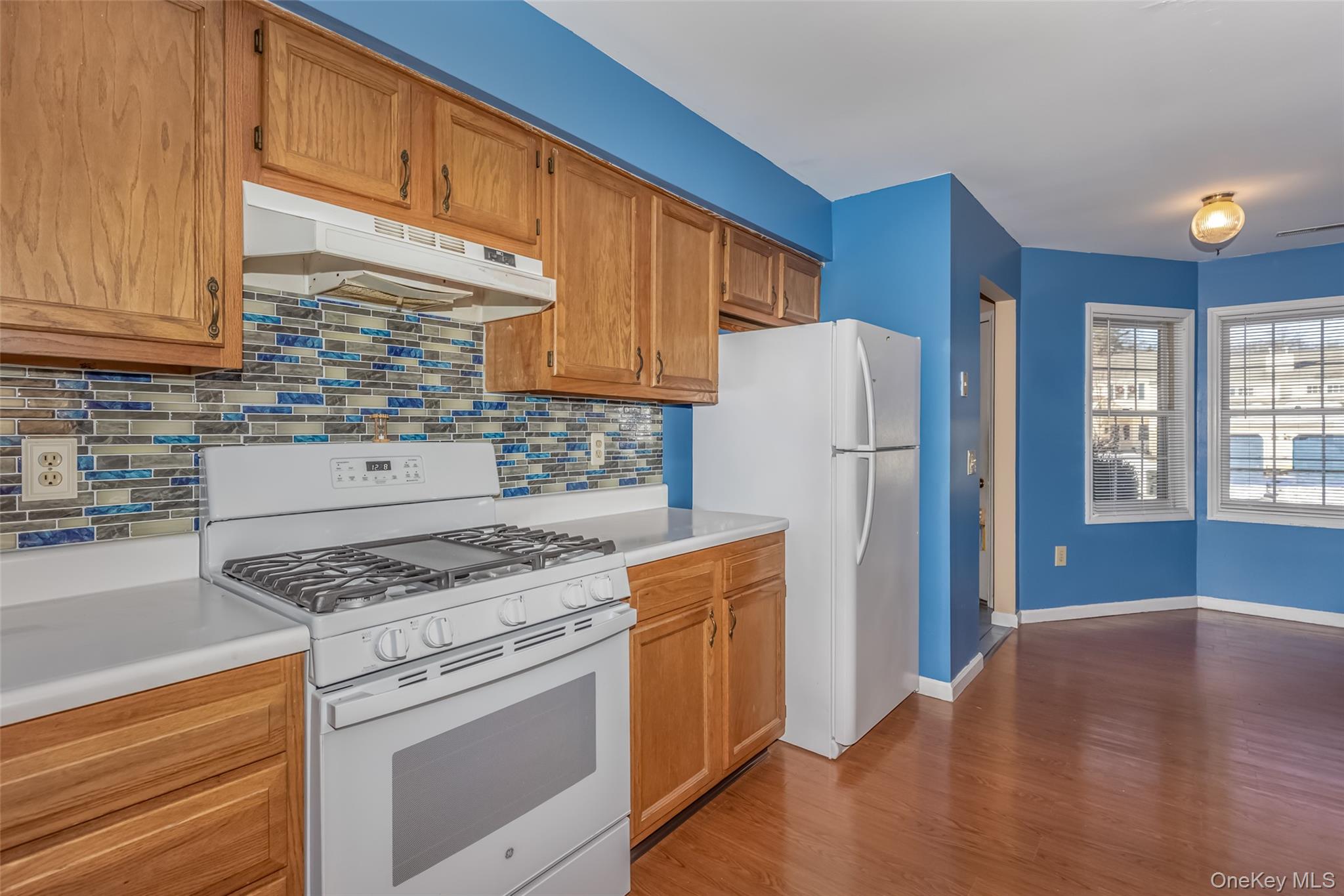 57 Winding Brook Drive Walden, NY 12586 - Photo 9 of 33 a kitchen with a stove a refrigerator and a sink