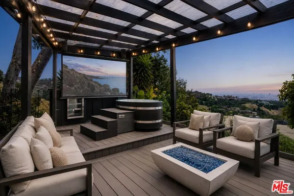 a outdoor living space with furniture and a fireplace