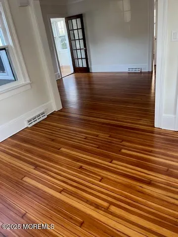 a view of a room with wooden floor