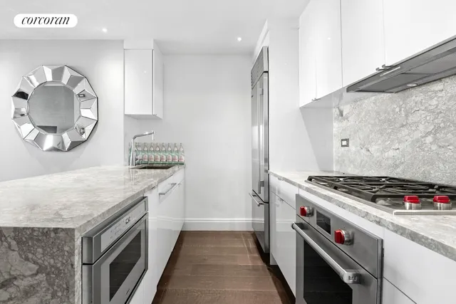 a kitchen with granite countertop a stove and a sink