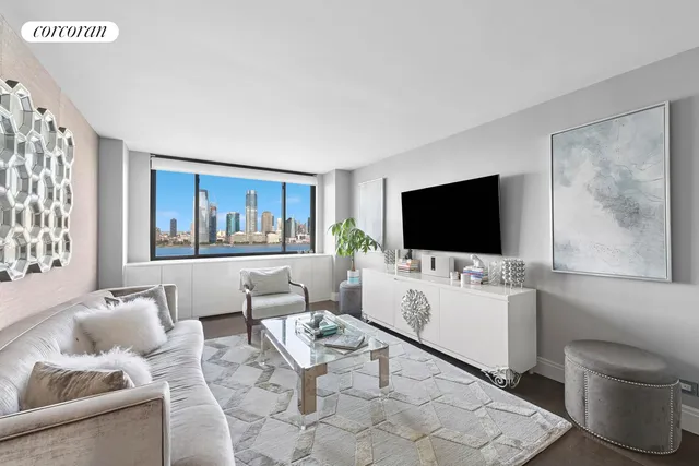 a living room with furniture a flat screen tv and a floor to ceiling window