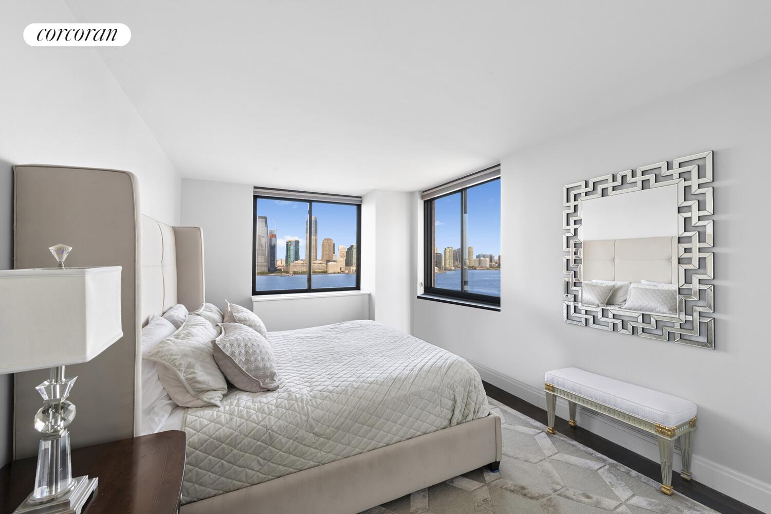 377 Rector Place, Unit 20B Manhattan, NY 10280 - Photo 5 of 10 a bedroom with a bed and a couch