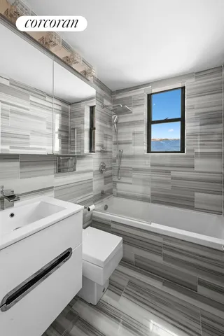 a bathroom with a sink a toilet and bathtub