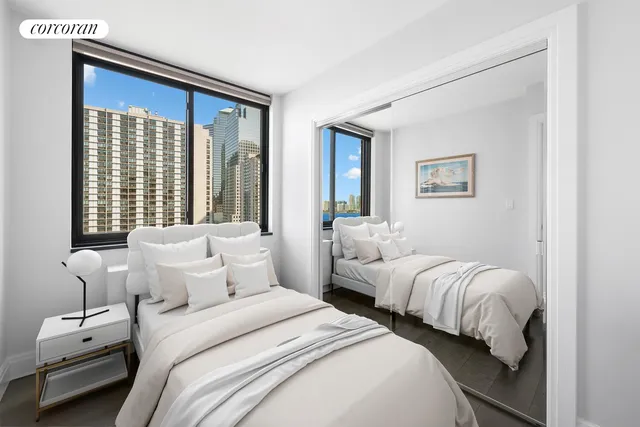 a bedroom with two beds and a window