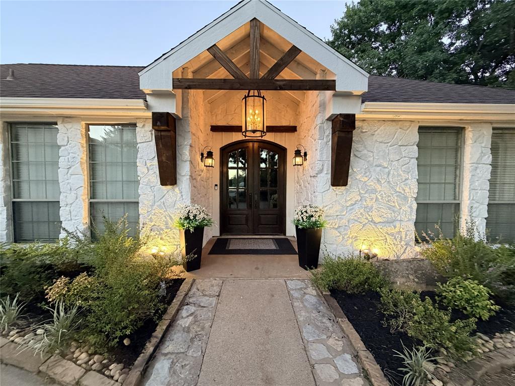 7204 Montgomery Road Midlothian, TX 76065 - Photo 2 of 32 Stone exterior featuring a prominent arched double-door entry