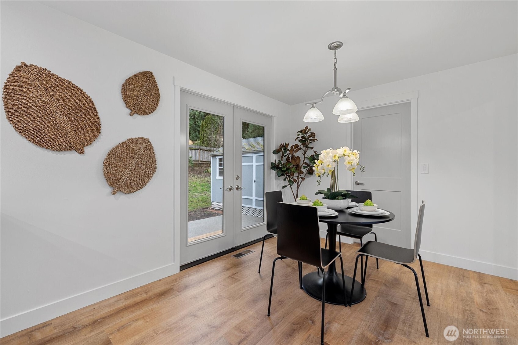 9218 Northeast 184th Place Bothell, WA 98011 - Photo 18 of 37 a view of a dining room and kitchen with furniture wooden floor and a chandelier