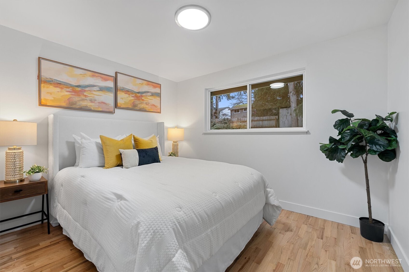 9218 Northeast 184th Place Bothell, WA 98011 - Photo 19 of 37 a bedroom with a bed and a potted plant