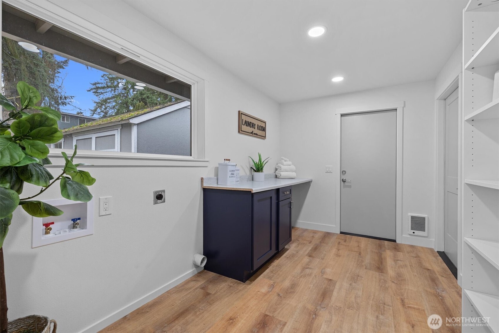 9218 Northeast 184th Place Bothell, WA 98011 - Photo 24 of 37 a room with a wooden floor and potted plant