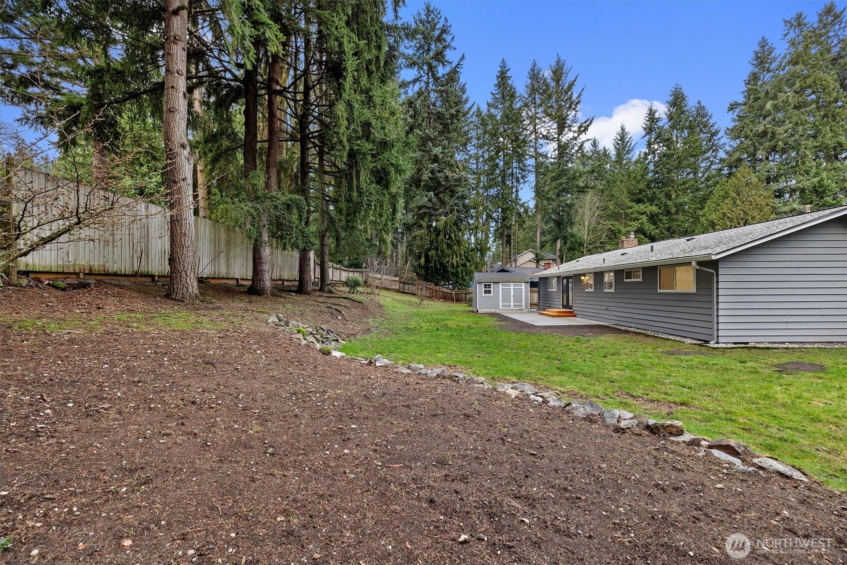 9218 Northeast 184th Place Bothell, WA 98011 - Photo 32 of 37 a view of a house with backyard and trees