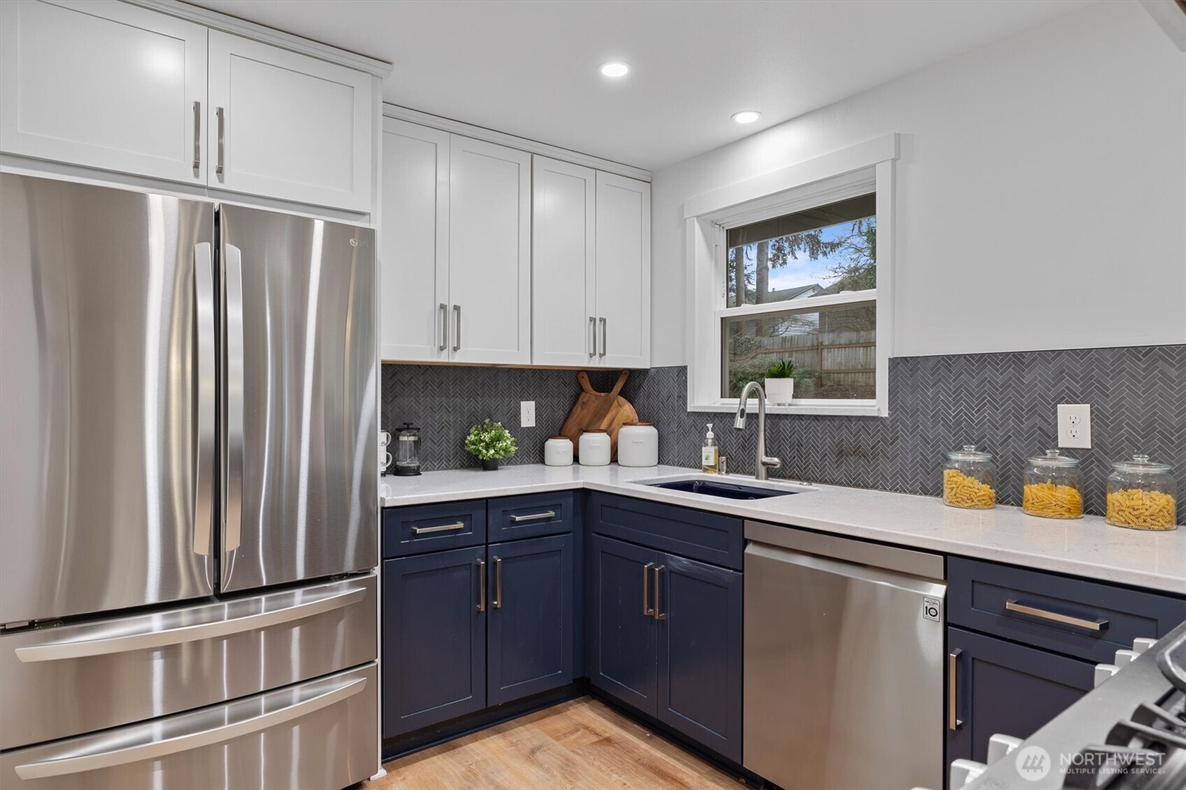 9218 Northeast 184th Place Bothell, WA 98011 - Photo 9 of 37 a kitchen with stainless steel appliances granite countertop a sink stove and refrigerator