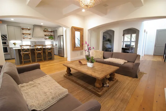 a living room with furniture and view of kitchen