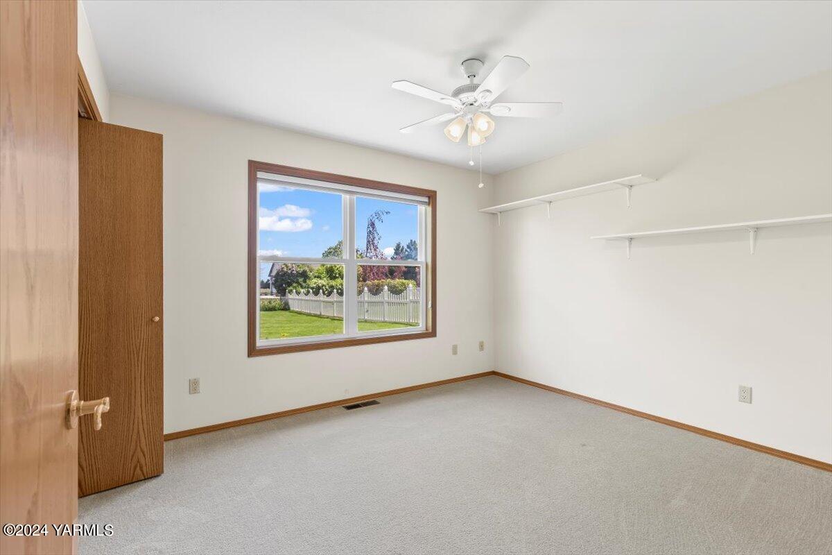 11810 West Barrett Road Yakima, WA 98908 - Photo 15 of 47 an empty room with windows and fan