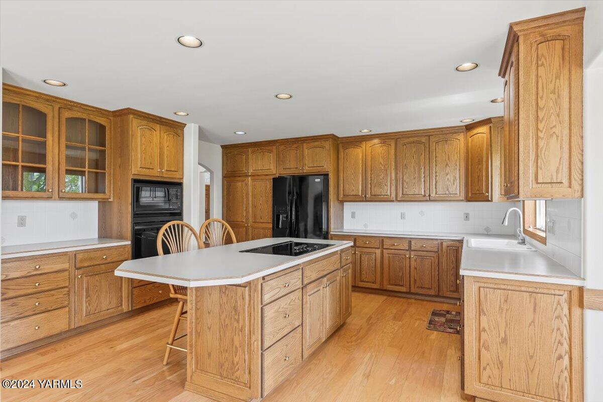 11810 West Barrett Road Yakima, WA 98908 - Photo 25 of 47 a kitchen that has a sink a stove and chairs