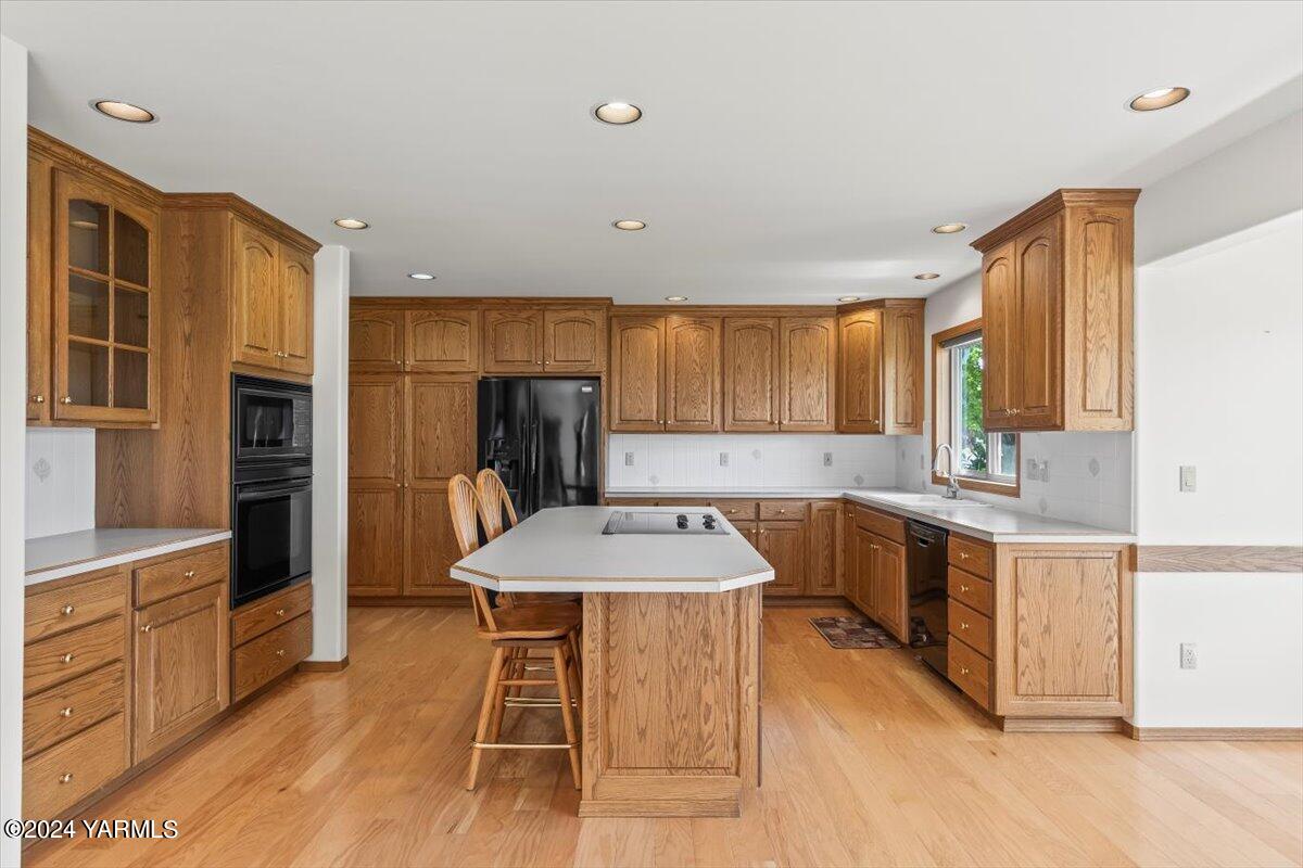 11810 West Barrett Road Yakima, WA 98908 - Photo 26 of 47 a kitchen with stainless steel appliances granite countertop a sink a stove a refrigerator cabinets and chairs