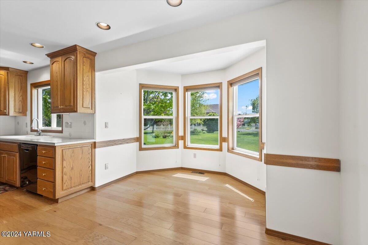 11810 West Barrett Road Yakima, WA 98908 - Photo 29 of 47 a large white kitchen with granite countertop a sink and a stove top oven
