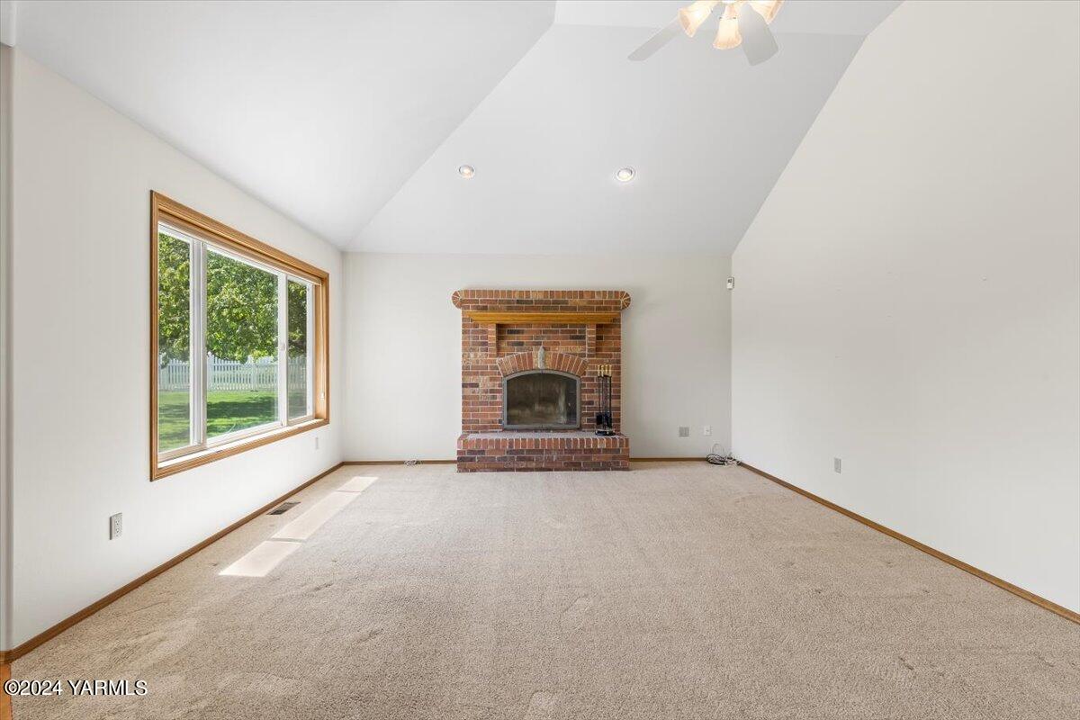 11810 West Barrett Road Yakima, WA 98908 - Photo 30 of 47 an empty room with large windows and fireplace
