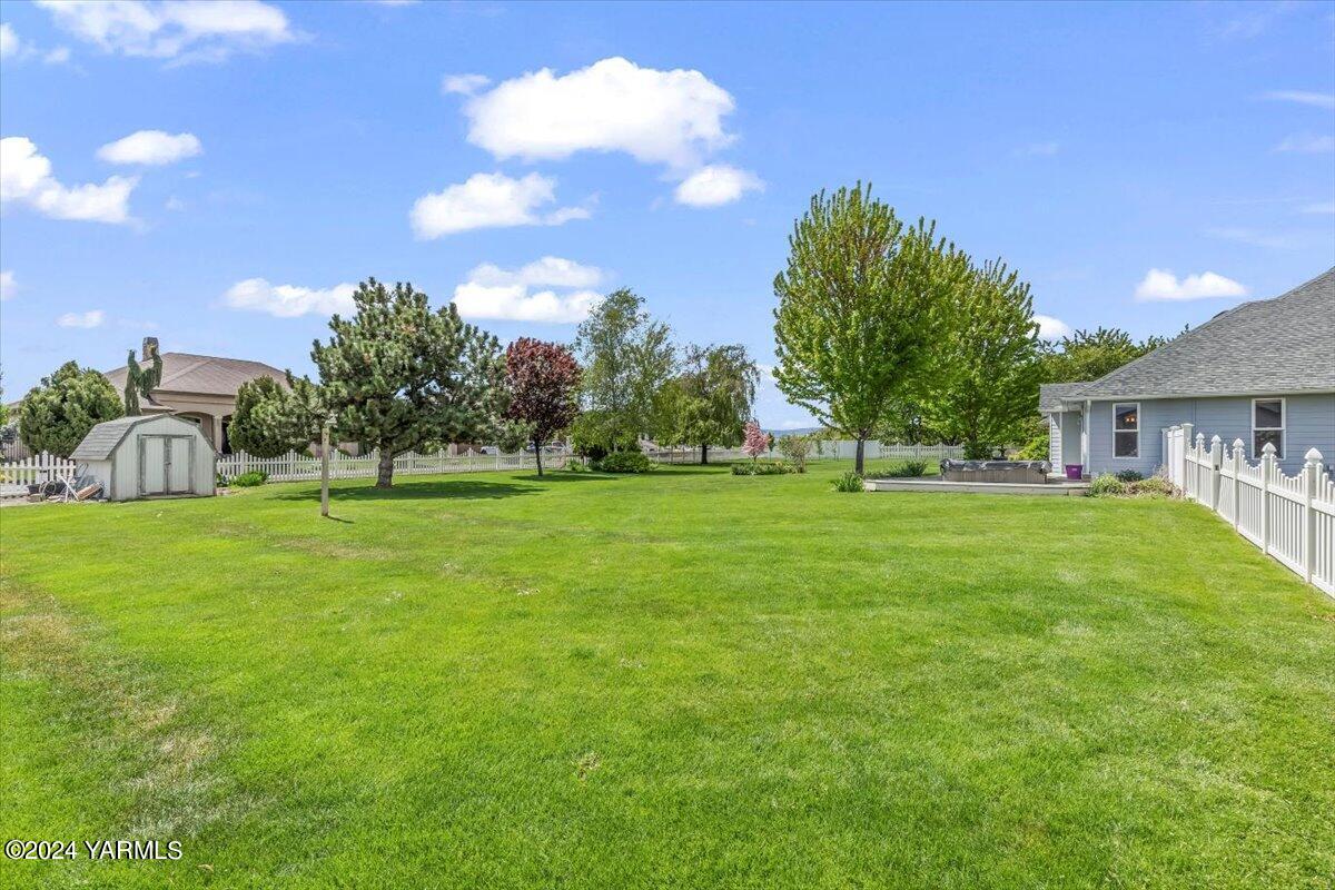 11810 West Barrett Road Yakima, WA 98908 - Photo 38 of 47 a view of house with garden and trees
