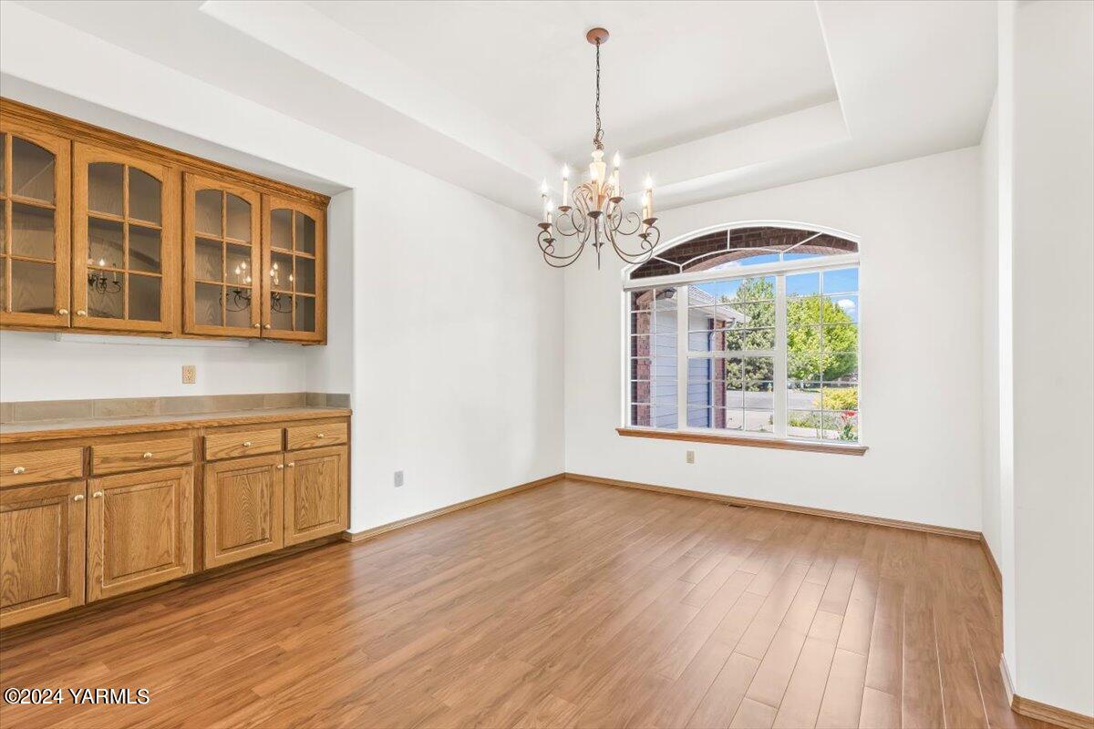11810 West Barrett Road Yakima, WA 98908 - Photo 8 of 47 a view of an empty room with a window and wooden floor