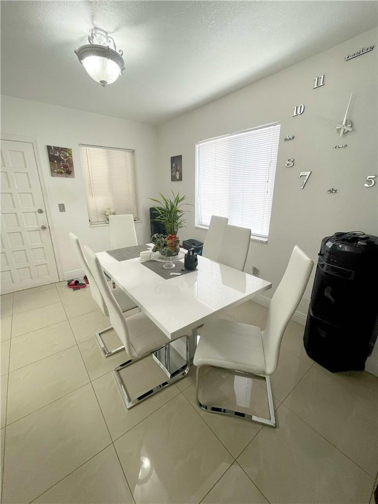 540 Beacom Boulevard Miami, FL 33135 - Photo 17 of 27 a dining room with furniture and a potted plant