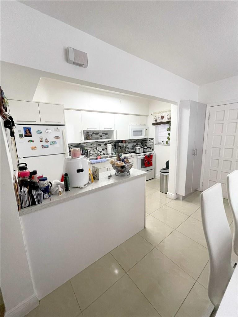 540 Beacom Boulevard Miami, FL 33135 - Photo 19 of 27 a kitchen with stainless steel appliances a sink and a refrigerator