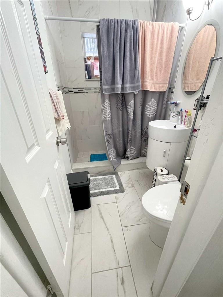 540 Beacom Boulevard Miami, FL 33135 - Photo 20 of 27 a bathroom with a sink a toilet and a mirror