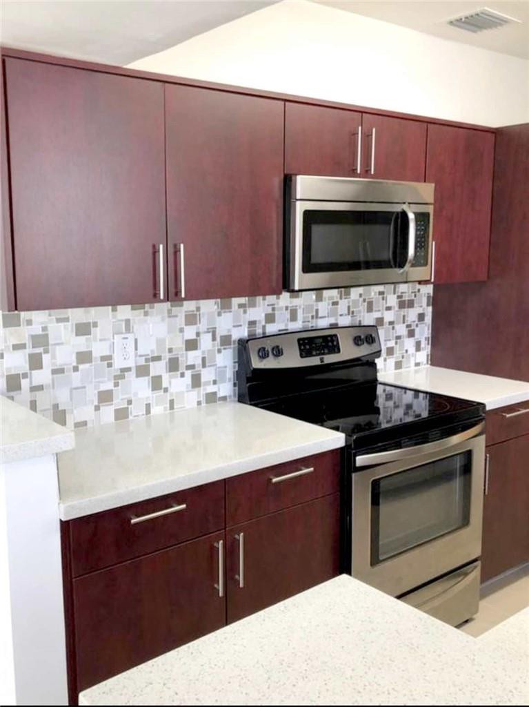 540 Beacom Boulevard Miami, FL 33135 - Photo 2 of 27 a kitchen with a sink and stainless steel appliances