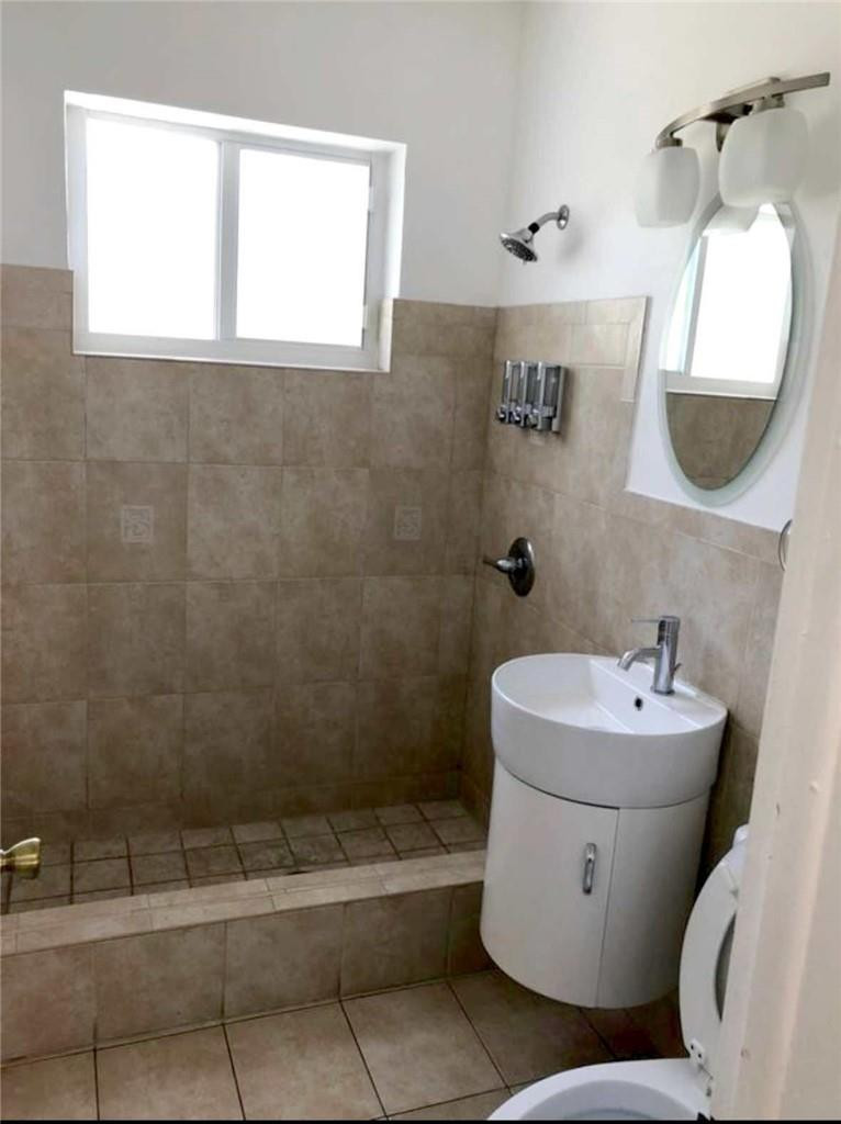 540 Beacom Boulevard Miami, FL 33135 - Photo 3 of 27 a bathroom with a sink mirror and window