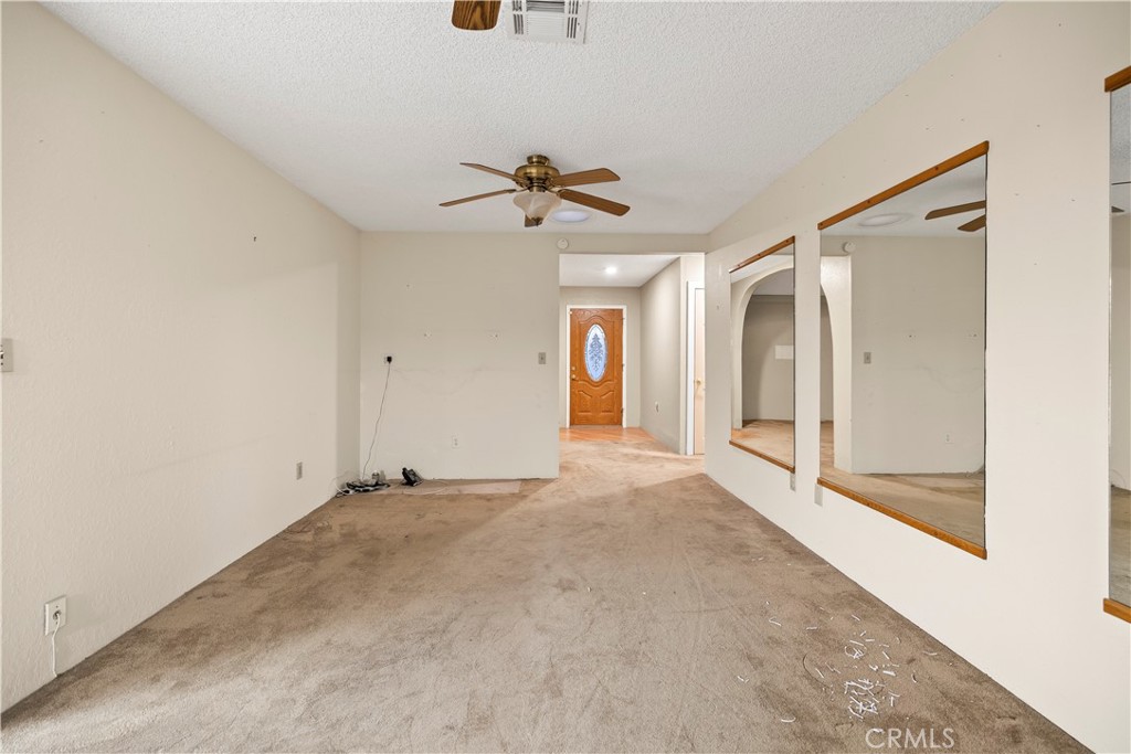 16464 Tullock Street Fontana, CA 92335 - Photo 14 of 43 a view of a big room with chandelier fan and windows