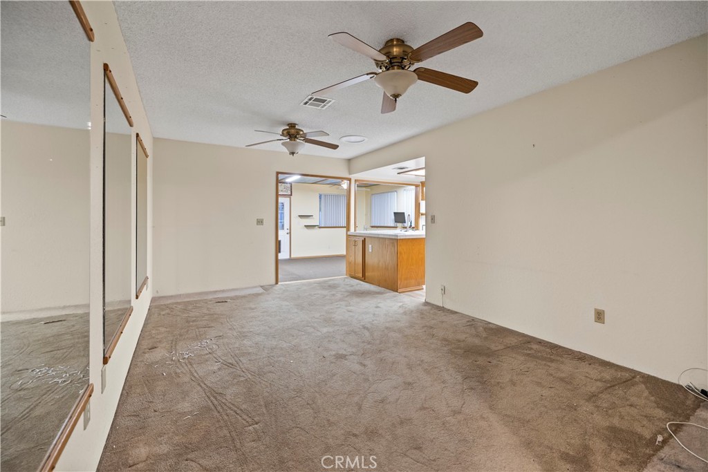 16464 Tullock Street Fontana, CA 92335 - Photo 15 of 43 an empty room with chandelier fan and windows