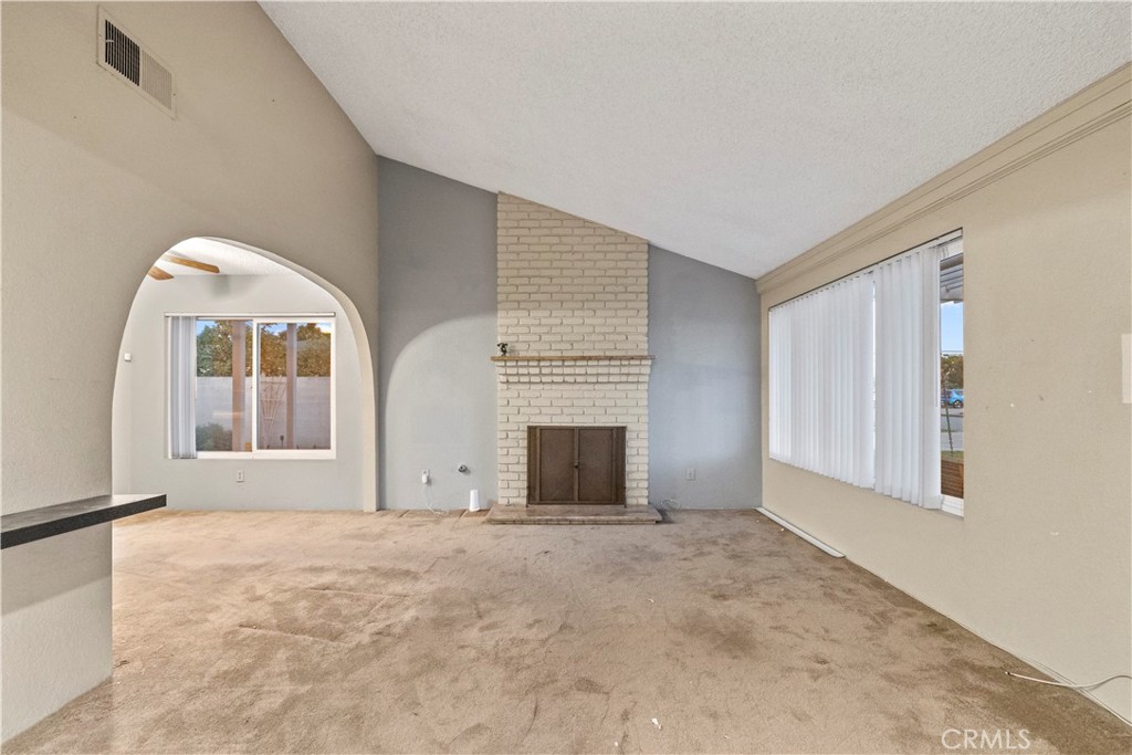 16464 Tullock Street Fontana, CA 92335 - Photo 2 of 43 a view of an empty room with window and fireplace