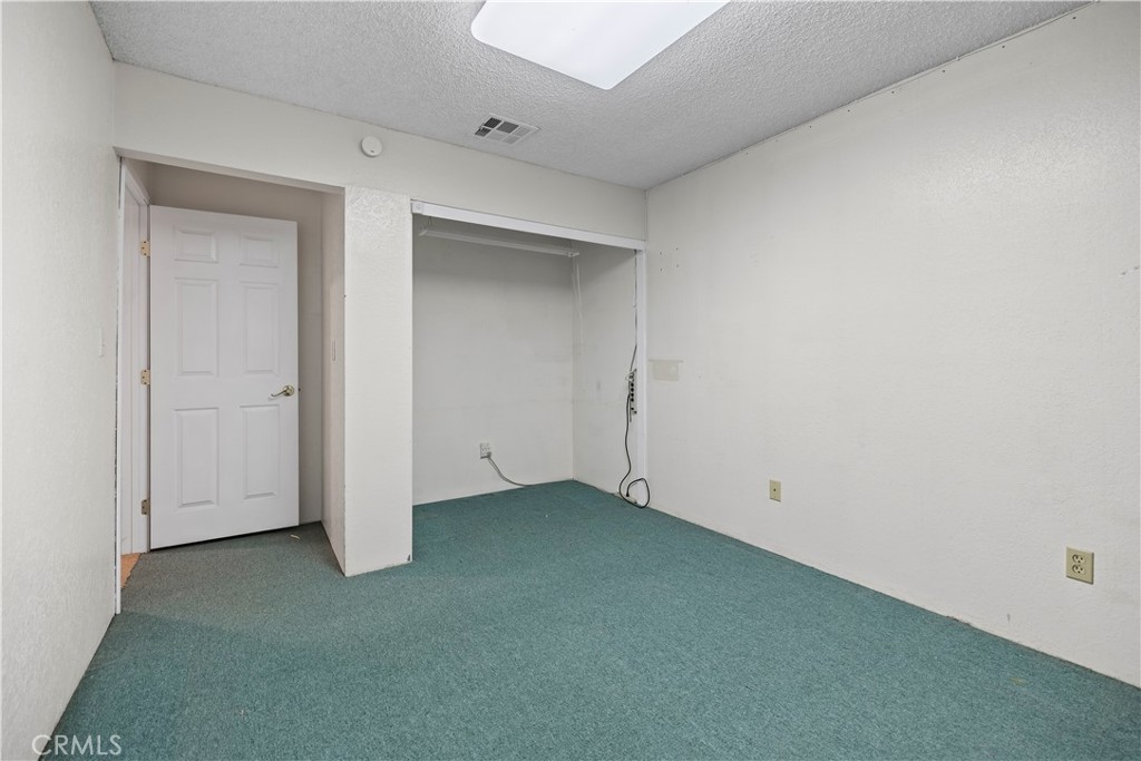 16464 Tullock Street Fontana, CA 92335 - Photo 25 of 43 an empty room with closet area