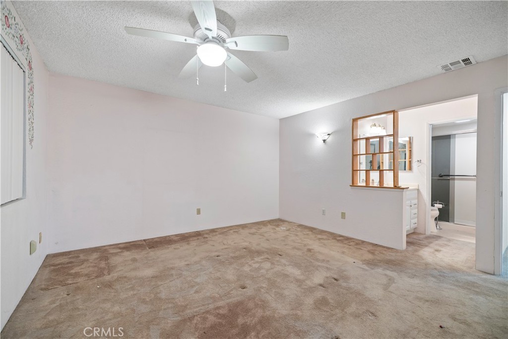 16464 Tullock Street Fontana, CA 92335 - Photo 28 of 43 an empty room with chandelier fan and windows