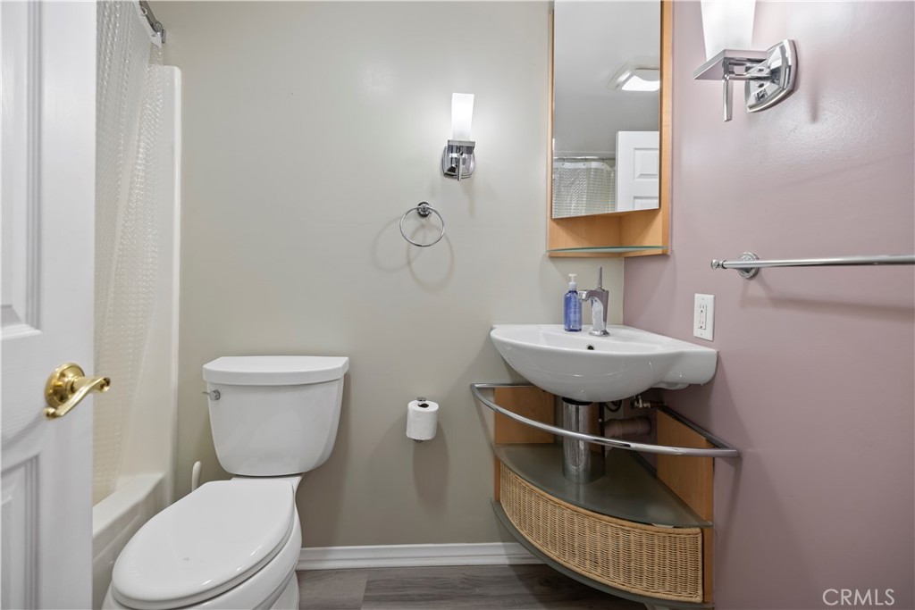 16464 Tullock Street Fontana, CA 92335 - Photo 30 of 43 a bathroom with a sink toilet and a mirror