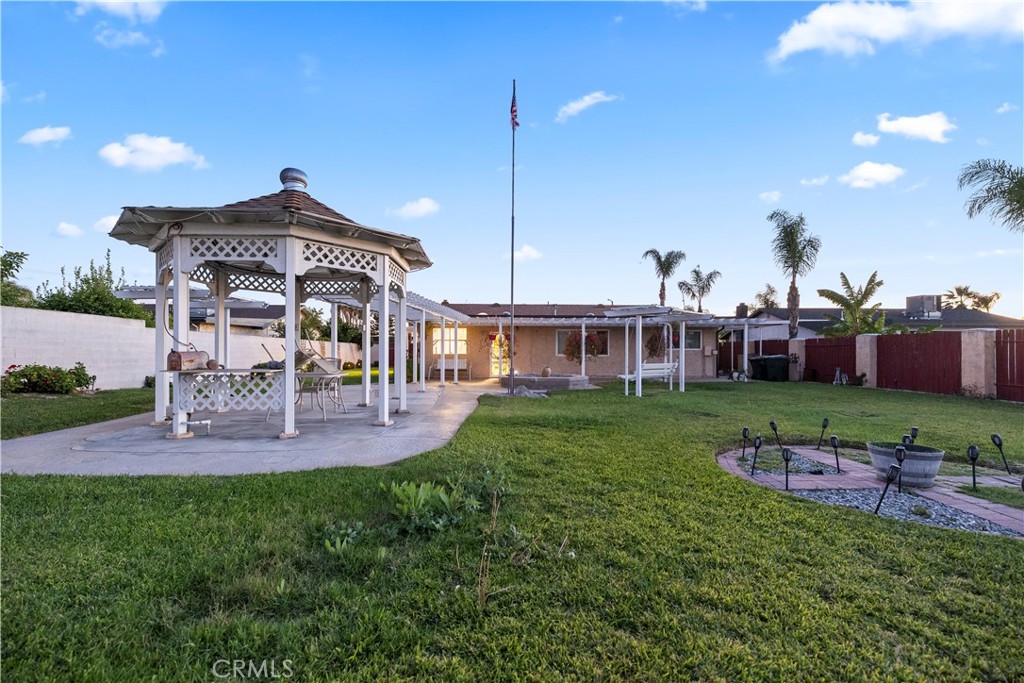 16464 Tullock Street Fontana, CA 92335 - Photo 37 of 43 a front view of a house with a big yard and a garden