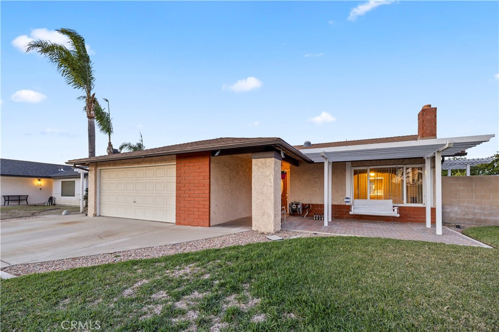 16464 Tullock Street Fontana, CA 92335 - Photo 43 of 43 a front view of a house with a yard and garage