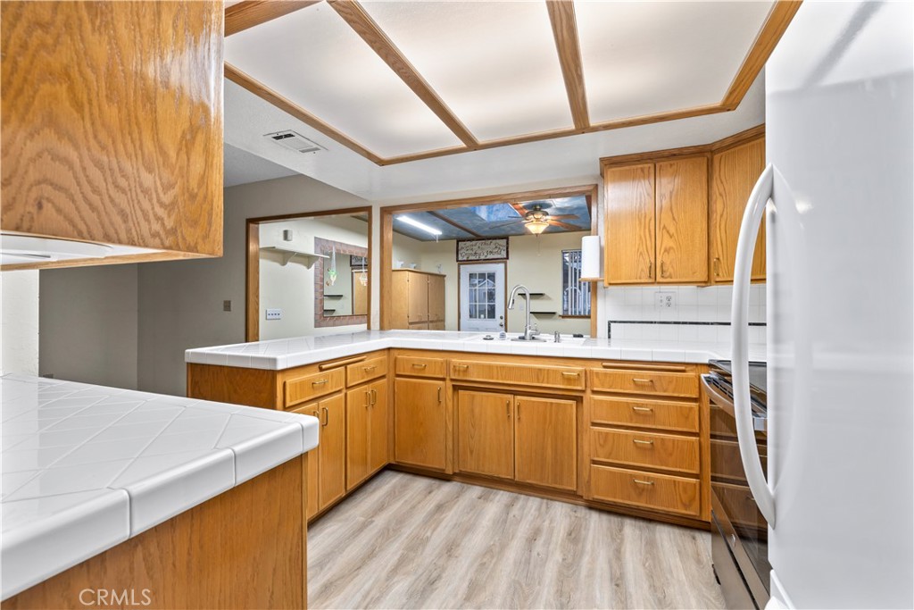 16464 Tullock Street Fontana, CA 92335 - Photo 9 of 43 a kitchen with stainless steel appliances granite countertop a sink and cabinets