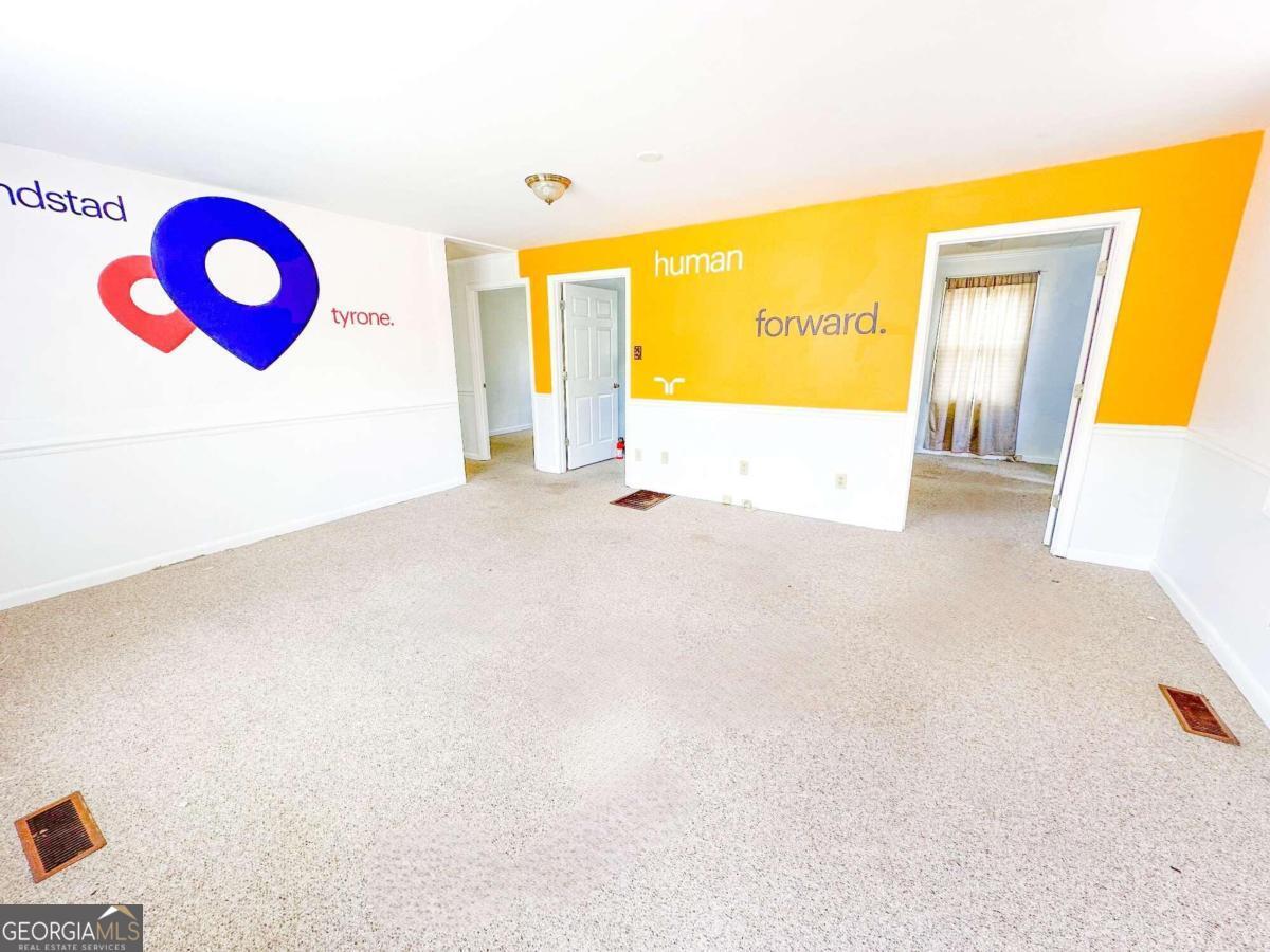 1922 Highway 74 Tyrone, GA 30290 - Photo 2 of 6 a view of an empty room and a window