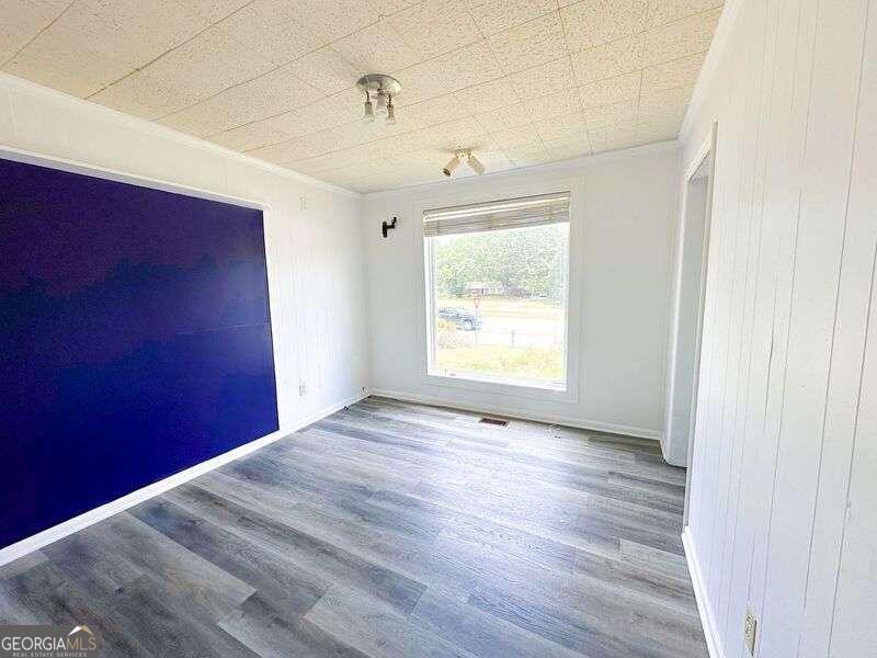 1922 Highway 74 Tyrone, GA 30290 - Photo 3 of 6 an empty room with wooden floor and windows