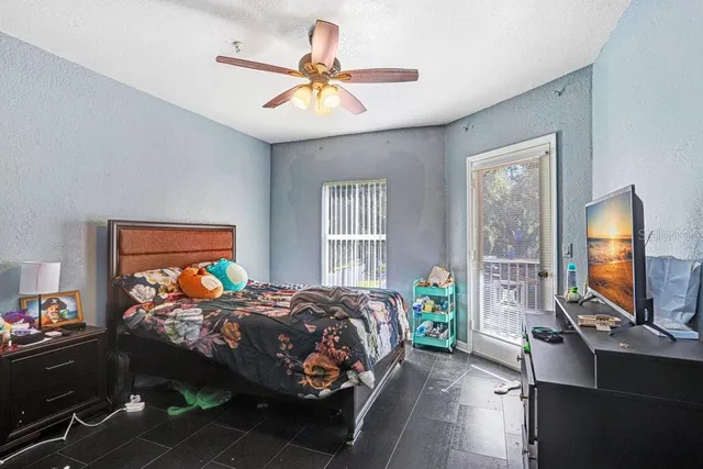 a bedroom with a bed and a chandelier