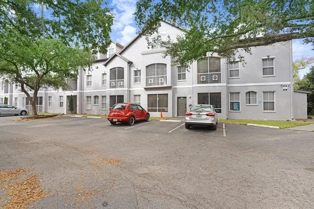 a car parked in front of a white house