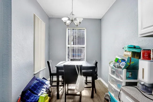 a view of a dining room with furniture and chandelier