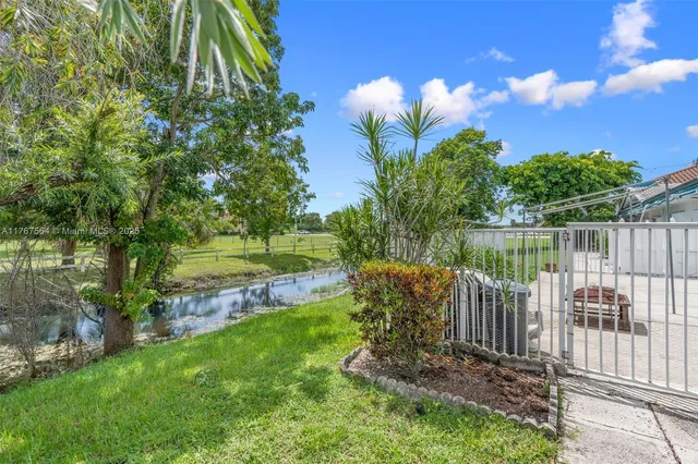 a view of a garden with wooden fence
