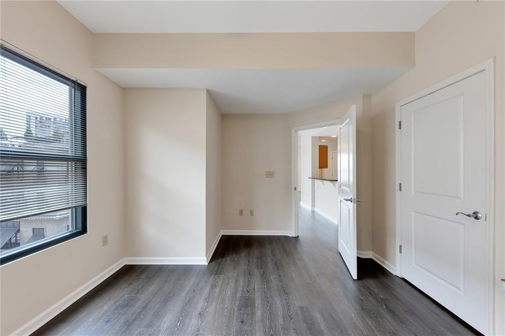 3040 Peachtree Road Northwest, Unit 704 Atlanta, GA 30305 - Photo 6 of 16 wooden floor in an empty room with a window