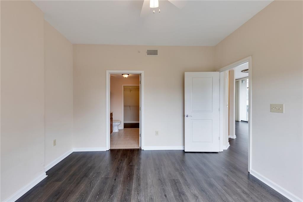 3040 Peachtree Road Northwest, Unit 704 Atlanta, GA 30305 - Photo 8 of 16 a view of an empty room with wooden floor and closet