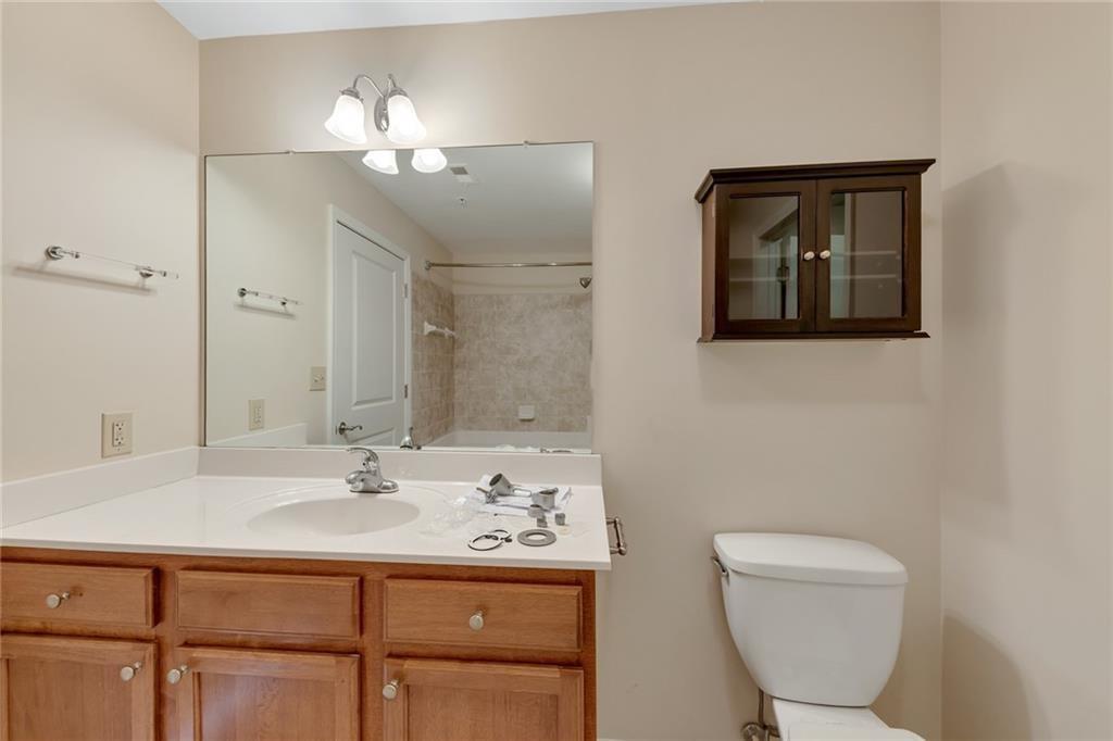 3040 Peachtree Road Northwest, Unit 704 Atlanta, GA 30305 - Photo 9 of 16 a bathroom with a toilet sink and mirror