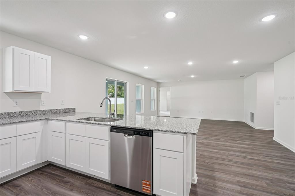 2155 Northwest 23rd Loop Ocala, FL 34475 - Photo 11 of 24 a kitchen with a sink cabinets and wooden floor